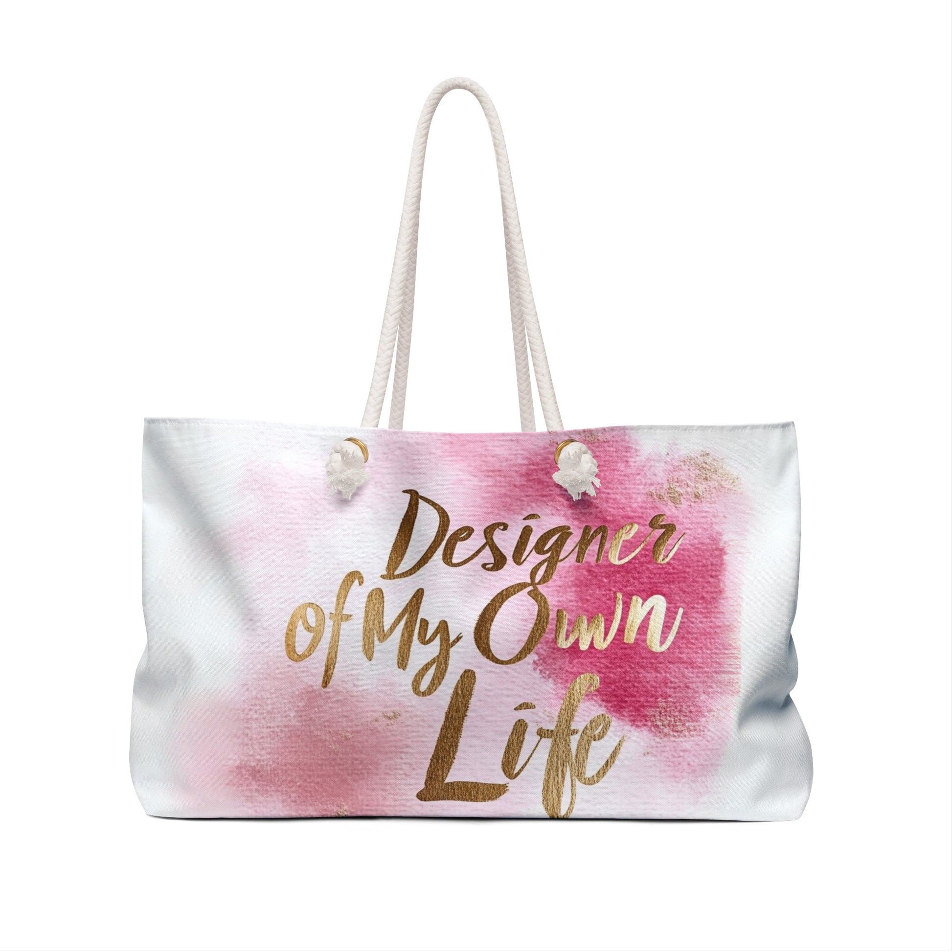 "DUO MODERN 'Designer of My Own Life' Weekender Tote in pink blush with gold font. Perfect for the modern jet-setter, combining elegance and practicality. Ideal for beach trips, luxe getaways, or city exploration."