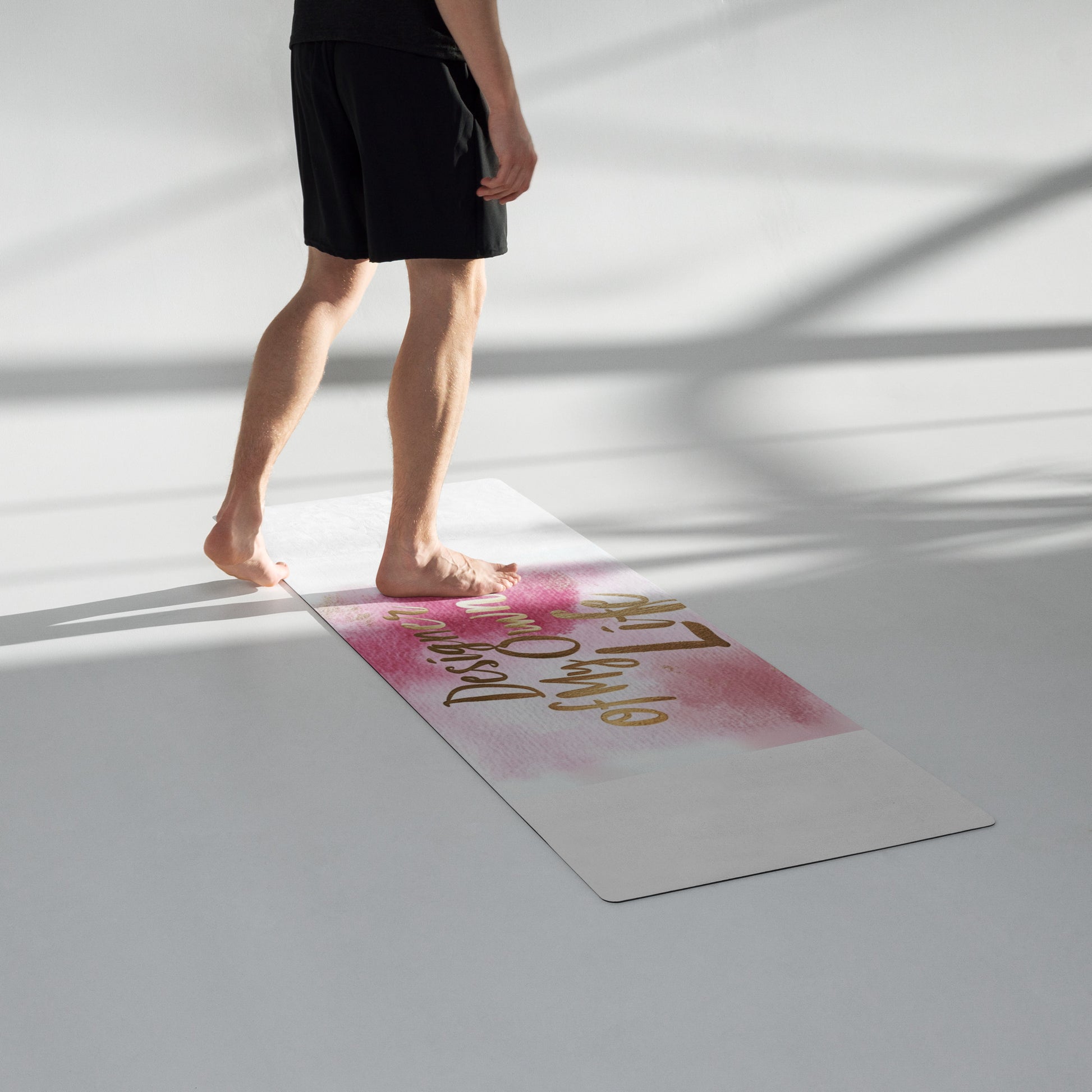 "DUO MODERN 'Designer of My Own Life' Yoga Mat in pink blush with gold font. Perfect for exercise, meditation, or stretching. Offers stability, comfort, and portability. Enhances your practice with style and functionality."